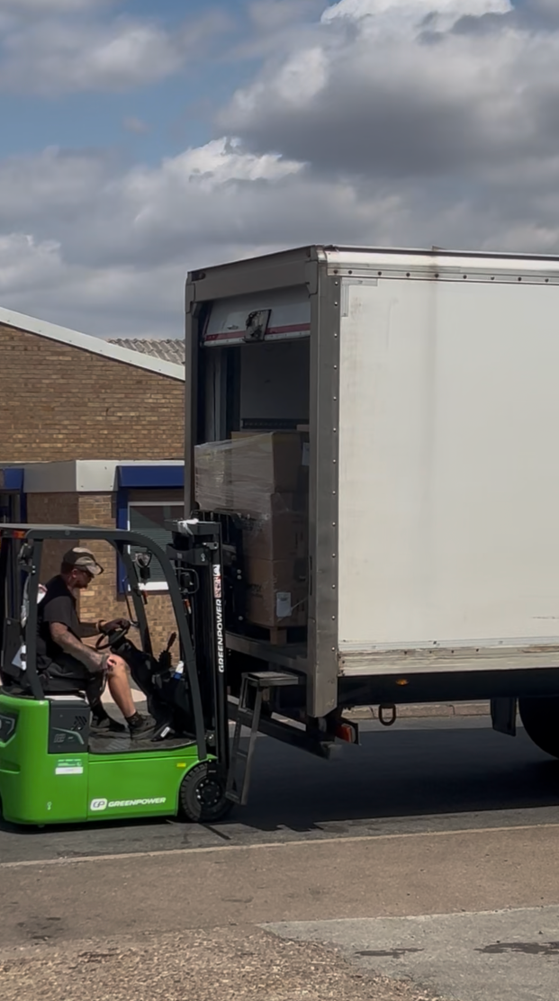 Forklift loading a wrapped pallet onto an outbound lorry