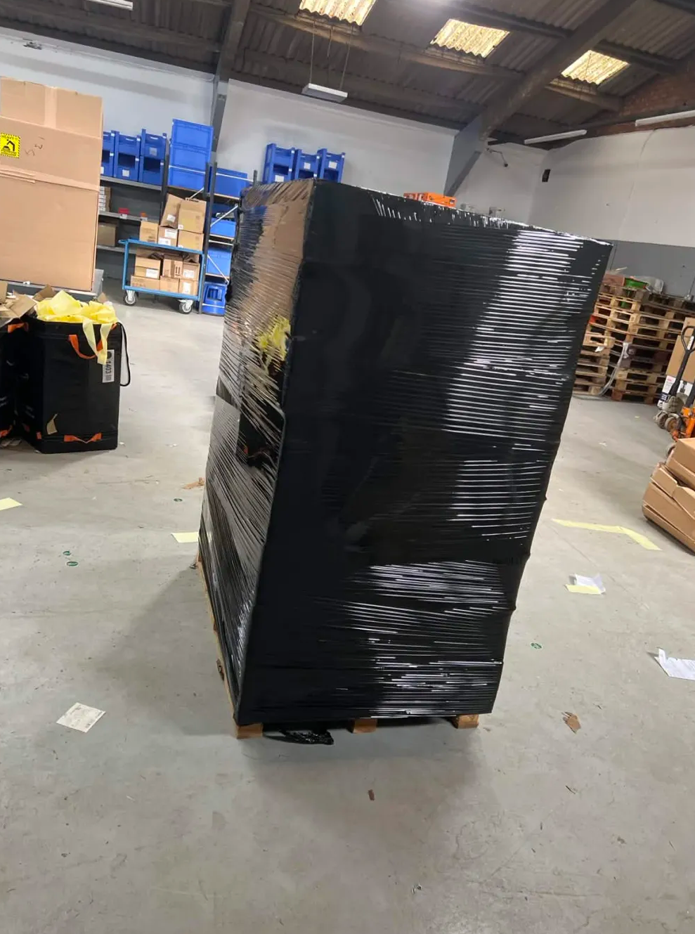 Spare pallets stacked and ready in the warehouse